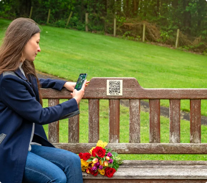 Scanning QR code on a memorial bench